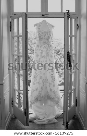 White wedding gown hanging in bridal suite