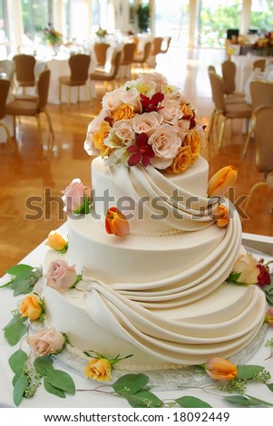 stock photo White wedding cake with roses on reception table