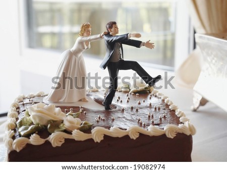 stock photo Funny wedding cake top bride chasing groom