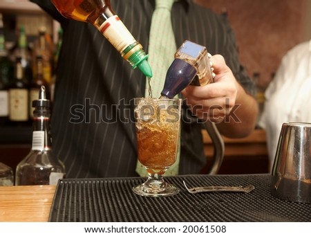 Bartender pouring mixed drink of rum and cola