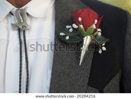 stock photo Bolo tie with classic red rose wedding boutonniere