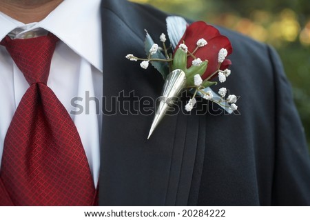 stock photo Classic red rose wedding boutonniere on suit of groom