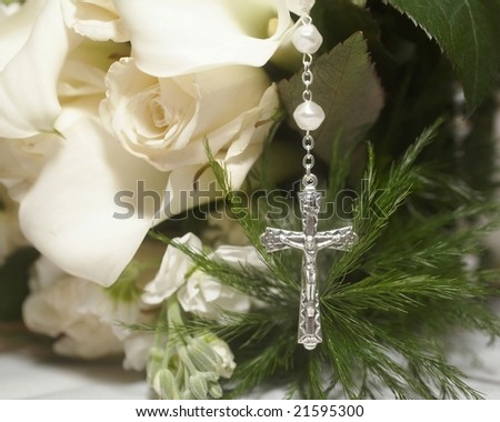 stock photo Silver cross on wedding bouquet of white roses