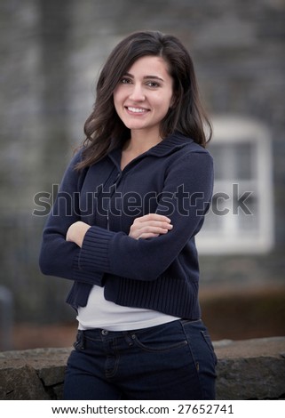 Beautiful confident friendly young woman outdoor portrait