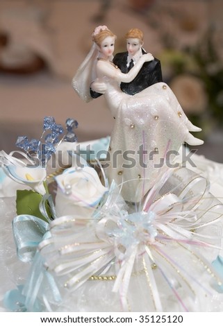 Closeup of wedding cake topper figurines at reception