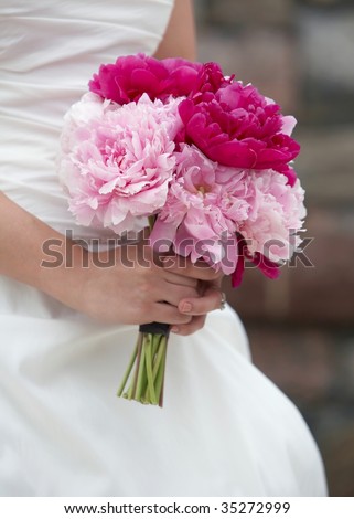 stock photo Bride holding wedding bouquet of pink and red carnations 