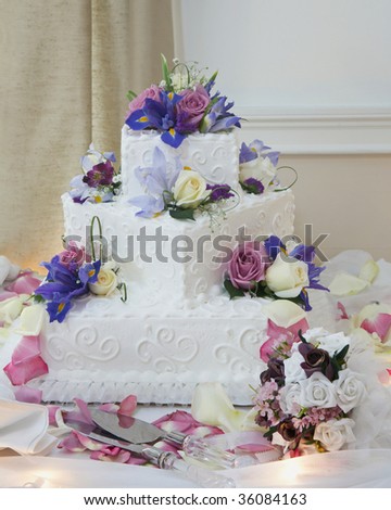 stock photo White wedding cake with flowers at reception table