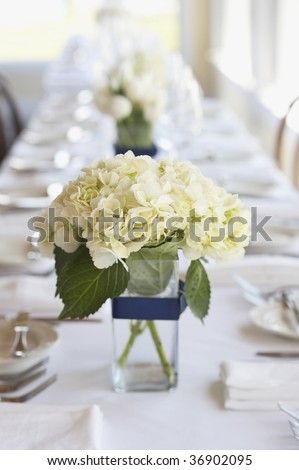 Table set for an event party or wedding reception, focus on bouquet