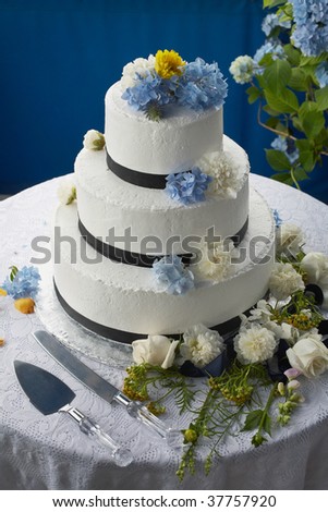 stock photo Wedding cake decorated with flowers on reception table
