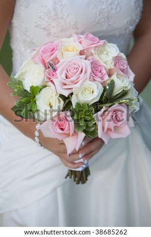 stock photo Pink and white rose wedding bouquet held by bride
