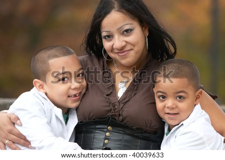 Smiling hispanic mother with two sons happy family