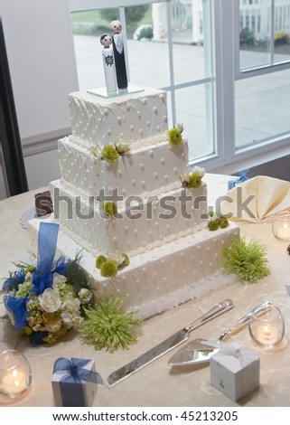 stock photo Modern white wedding cake on reception table