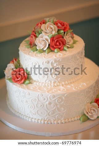 stock photo White wedding cake with orange and green flowers