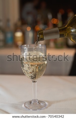 Closeup of white wine be poured at bar