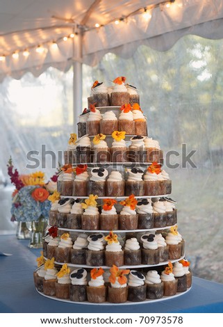 stock photo Wedding cake of cupcakes with flowers at reception