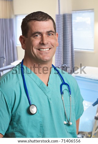 Smiling handsome doctor man in hospital