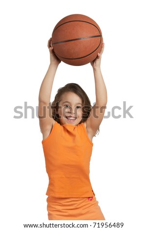 Happy five year old girl playing with basketball