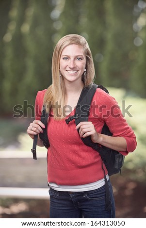 Pretty young woman high school or college student on campus