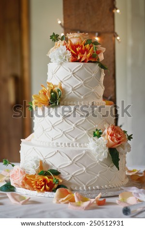 White wedding cake with flowers at wedding reception