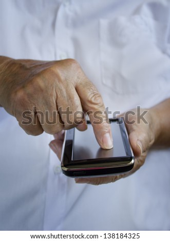 Mobile phone. Finger pointing on touch screen.