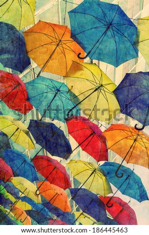 Lots of umbrellas coloring the sky overlaid with grunge texture.