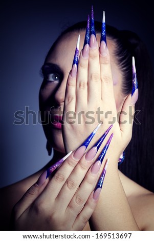 Beauty makeup. Purple make-up and colorful nails.