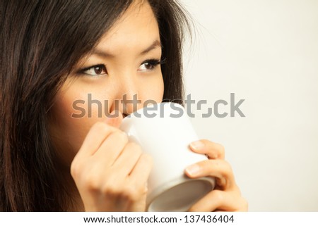 Asian woman with hot drink