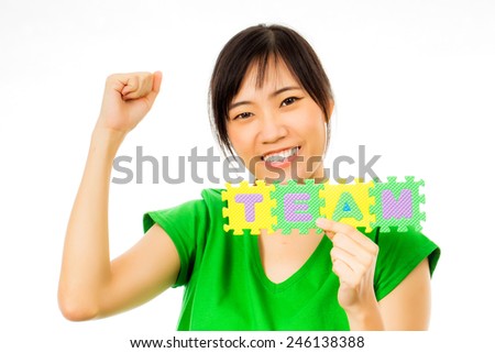 asian woman holding alphabet puzzle with the word team