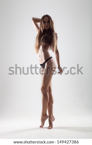 young, slender and athletic girl posing in underwear on a white background