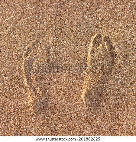 Footprints on the beach sand.Traces on the beach. Footsteps
