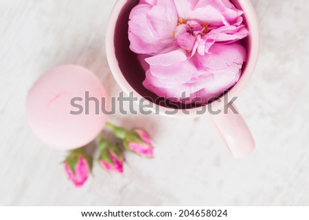 Tea cup with rose and macaroons, pastel colored, selective focus