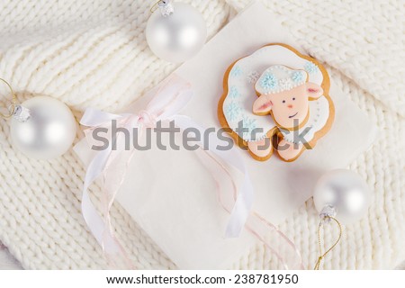 Christmas composition with white gingerbread sheep on knitted background. Year of the Sheep