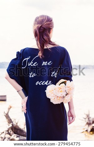 Young brunette woman in navy blue dress 