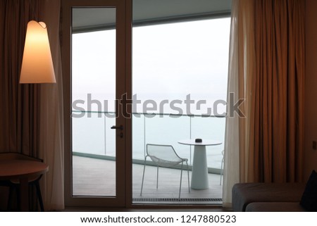 Living room with glass door to balcony. Sea view.
