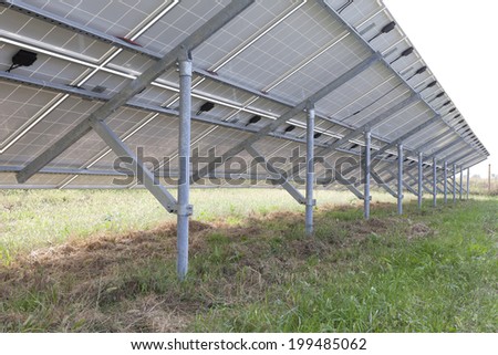 Ecology electric energy farm with solar panel battery in green field and modern solar panels in a beautiful green field