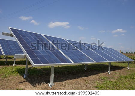 Ecology electric energy farm with solar panel battery in green field