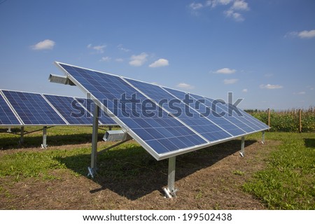 Ecology electric energy farm with solar panel battery in green field