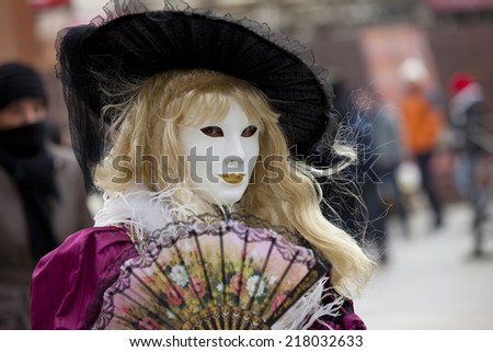 Venice, Italy -  February 11 2012: Woman with typical venetian carnival costume at the Carnival of Venice. Shot in St. Mark's Square.