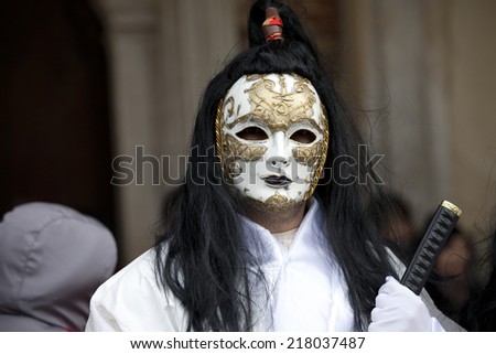 Venice, Italy - February 11, 2012: People posing wearing a typical Carnival mask in St. Mark's Square