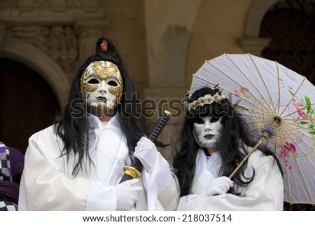 Venice, Italy - February 11, 2012: People posing wearing a typical Carnival mask in St. Mark\'s Square