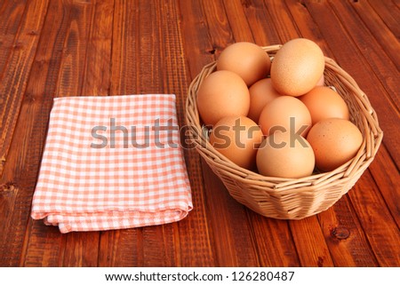 Fresh chicken eggs in the basket next to vintage tablecloth