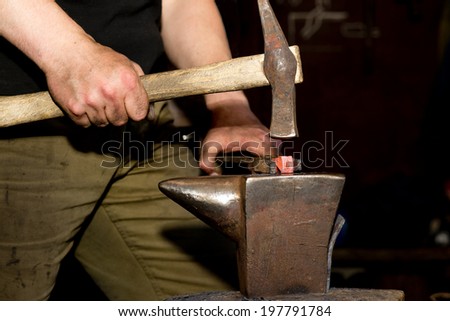 process wrought hammering hot iron on the anvil old