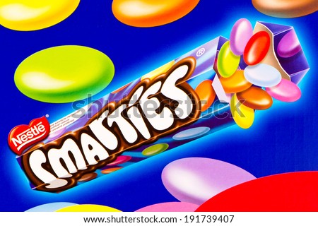ARAD, ROMANIA - April 8, 2012: Tube of Nestle Smarties printed on cardboard box. Nestle Smarties are a colour-varied sugar-coated chocolate confectionery. Studio shot.