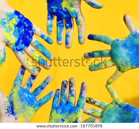 Painted hands on a yellow background.  Painted hands.