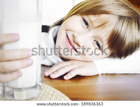 Little girl drinking milk. Little girl with milk.