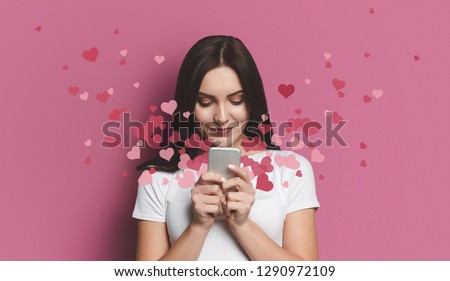 Valentine day concept, love mail - hearts flying out smartphone in womans hands