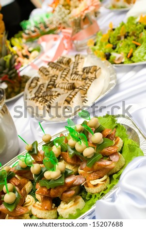 Catering buffet style - different sandwiches and pastry beautifully decorated on the trays