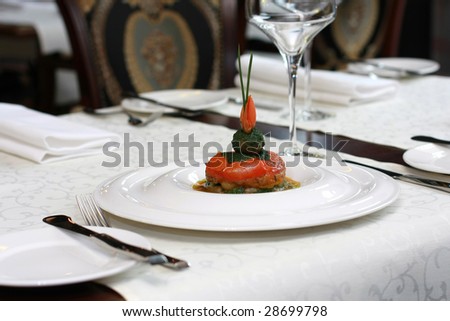 Vegetarian creative food in luxurious restaurant - baked tomatoes in sauce