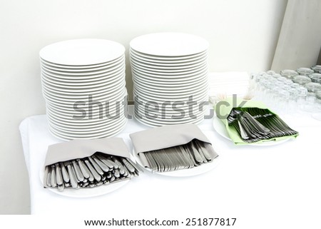 Catering - stacks of plates and cutlery served for guests