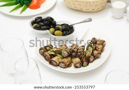 Catering - served table with aubergine rolls and olive snacks